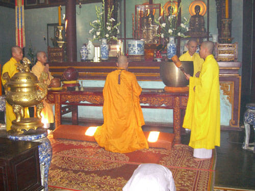 Buddhist monks praying in a temple in Hue, Vietnam