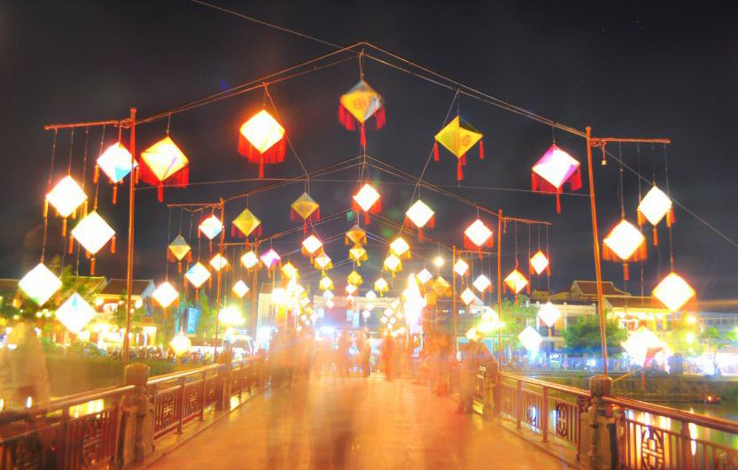 The nicely lit up bridge crossing over the river, Hoian