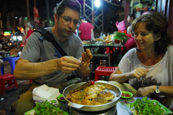 A couple enjoying street food in Hanoi