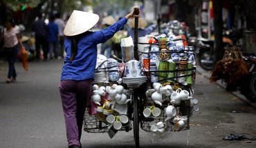 Ceramic vendor walking on the street of Hanoi