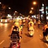 Along the hustling and bustling streets of saigon at Night on the back of Vespa