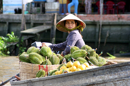 Fruit seller in Cai Be Floating Market of mekong delta