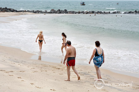 Some tourist is walking on Mui Ne beach