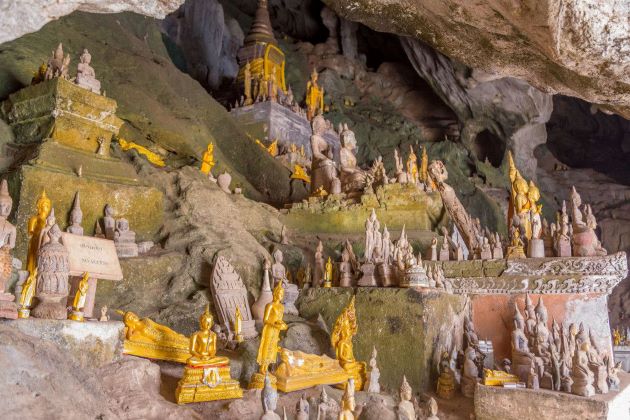 statues inside pak ou cave in luang prabang
