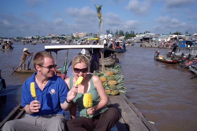 visit cai be floating market by boat - Vietnam adventure tours