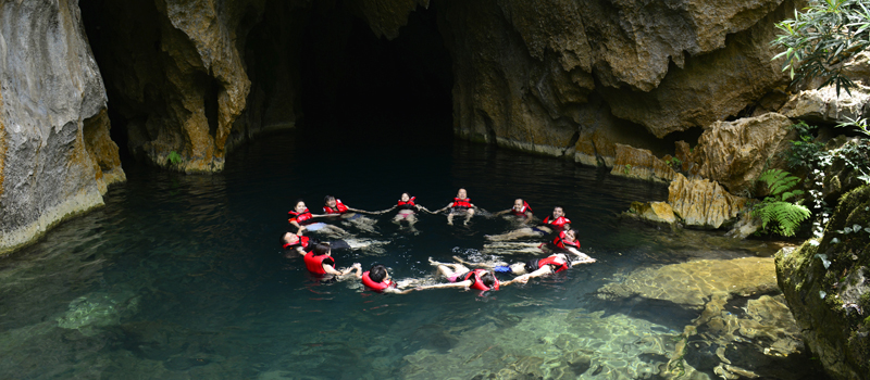 Swimming in crystal clear water of E cave (Trung Tre cave)