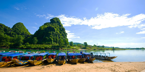 Walk to boat whraf and take a pleasant boat trip to Phong Nha Cave