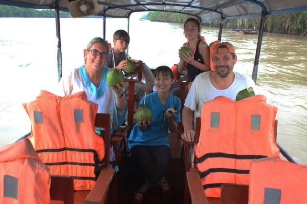 a family on boat trip at mekong delta