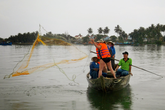 See and try casting fishing net on boat