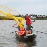 Tourist casting net fishing in Hoi An