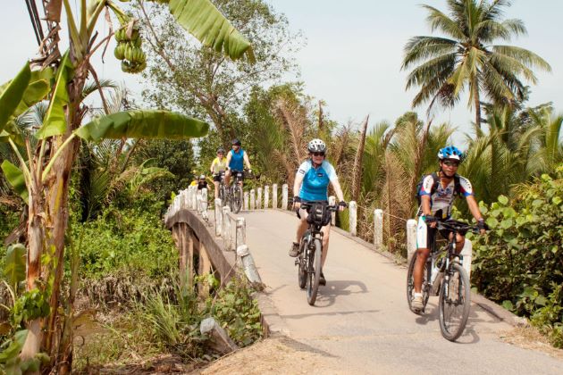 cycle throug village paths in mekong delta