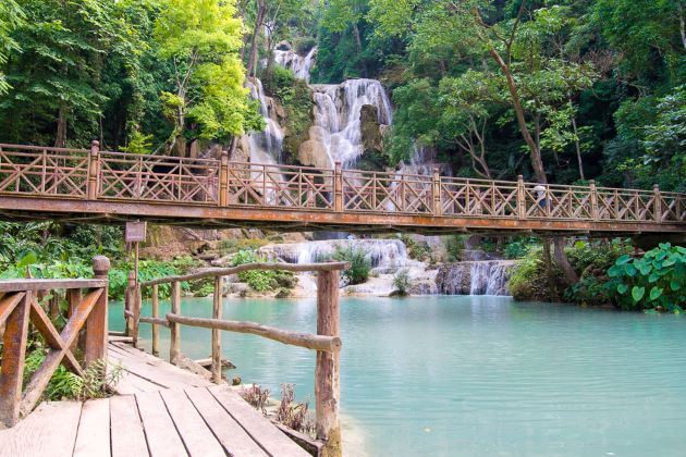 kuang si waterfall with wooden bridge 1