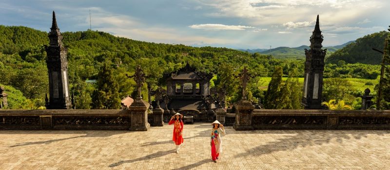 women in traditional dress at khai dinh tomb