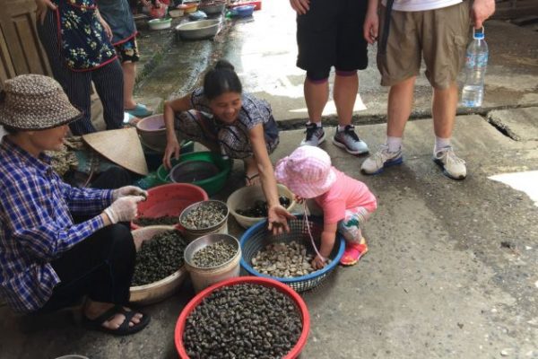 family visit local market in dong ngac village