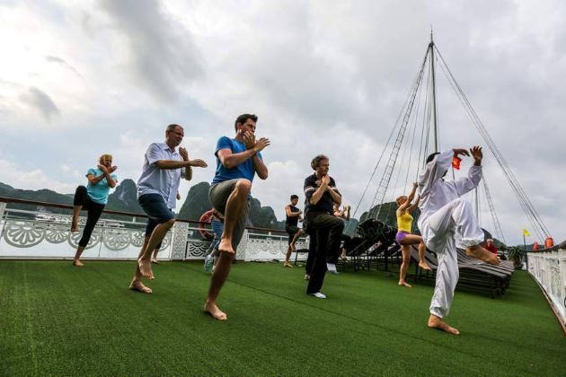 tai chi lesson on sundeck in halong bay