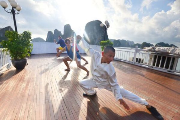 practice taichi with master at halong bay in the morning