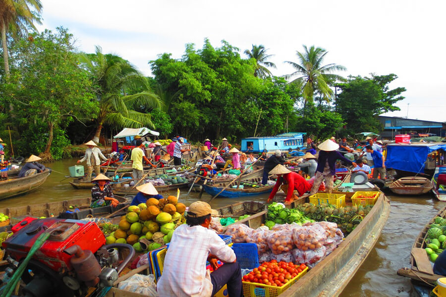 Local Boats Exchanging Fruit And Vegetable In Cai Be Floating Market